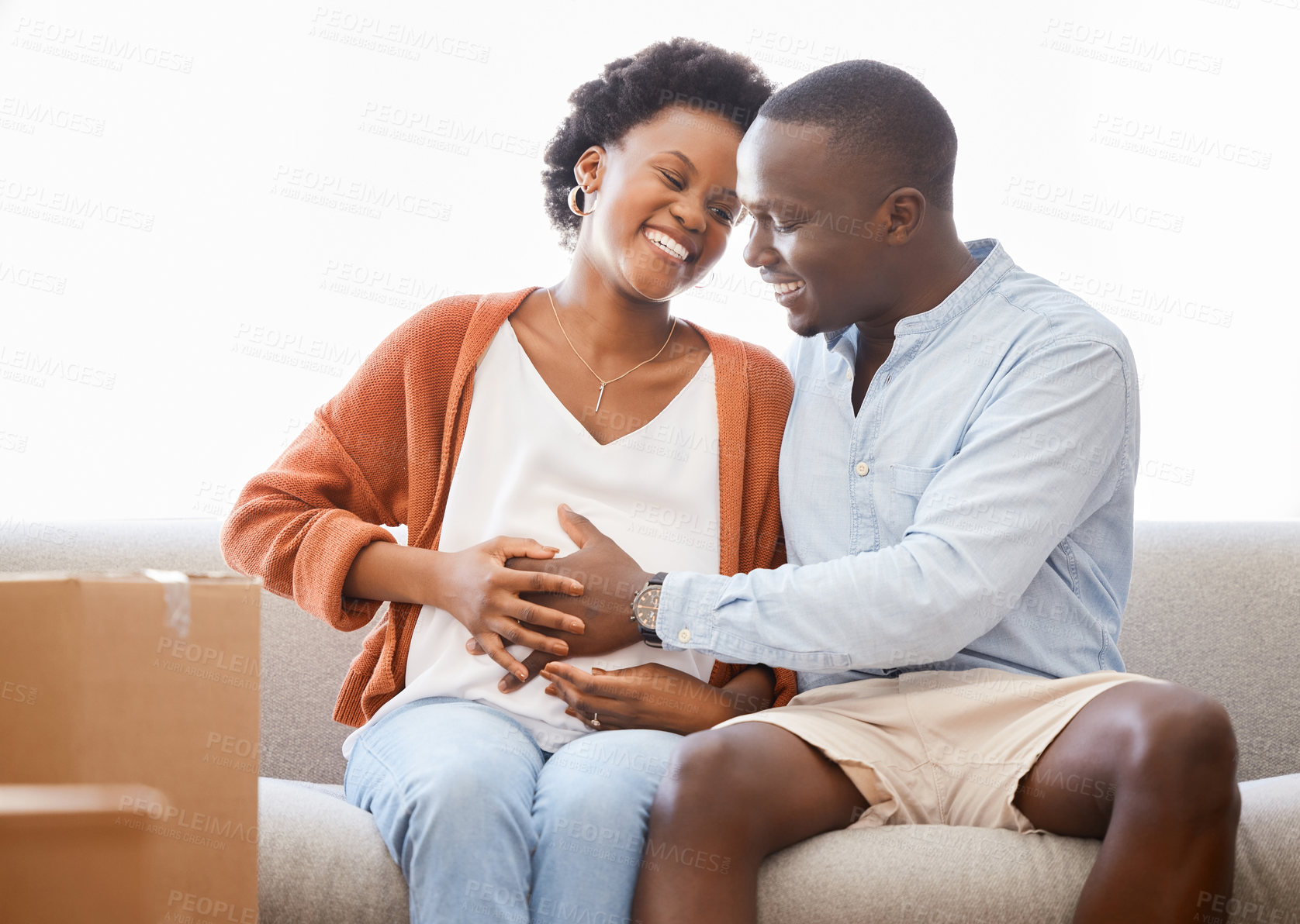 Buy stock photo Happy, pregnant and couple moving with boxes on sofa, living room or new house, mortgage investment or real estate. Black people, pregnancy and buying property, renting home for future baby or family