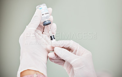 Buy stock photo Shot of a scientist extracting medication using a syringe from an ampoule with 