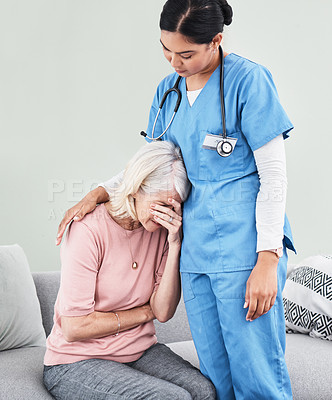 Buy stock photo Shot of a female nurse comforting her patient