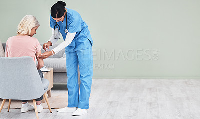 Buy stock photo Shot of a female nurse giving her patient an injection