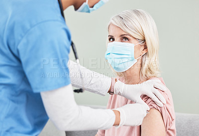 Buy stock photo Shot of a female nurse giving her patient an injection