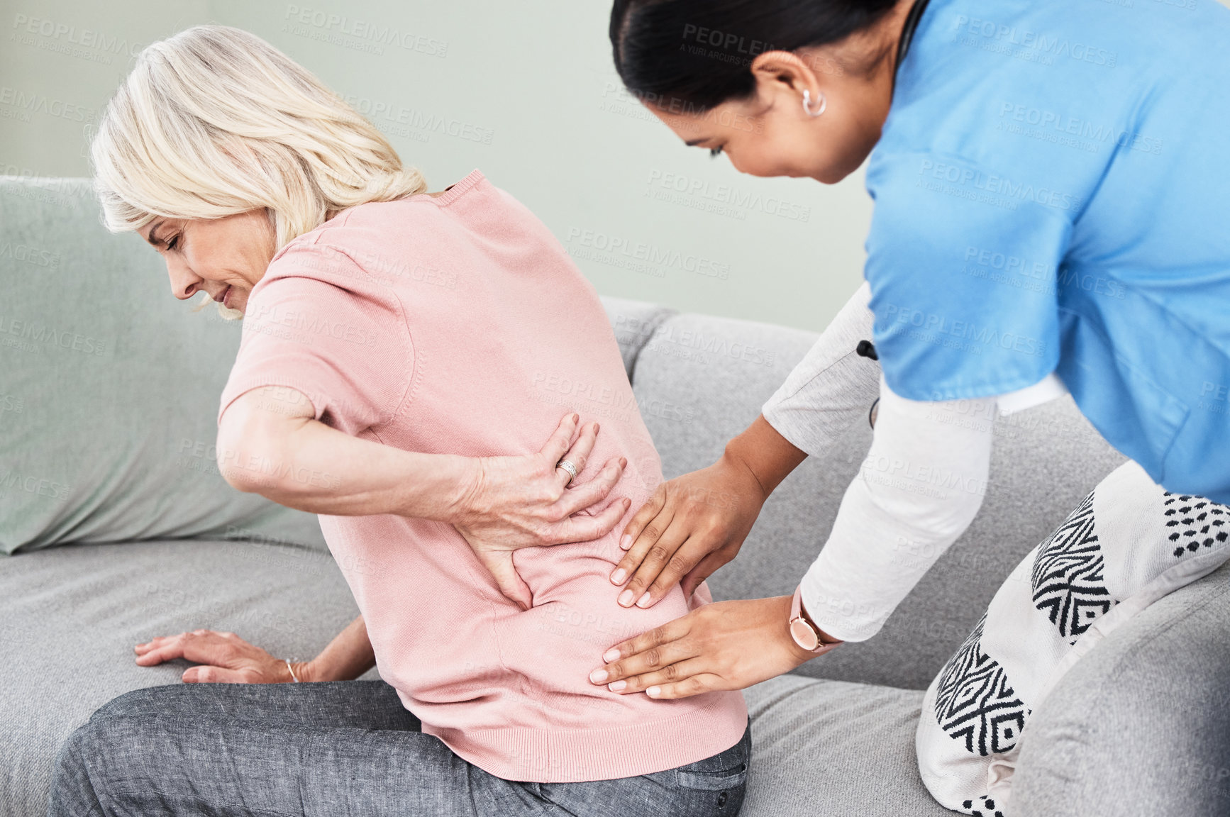 Buy stock photo Shot of a female nurse massaging her patient's back