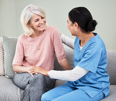 Buy stock photo Shot of a female nurse sitting with a senior patient