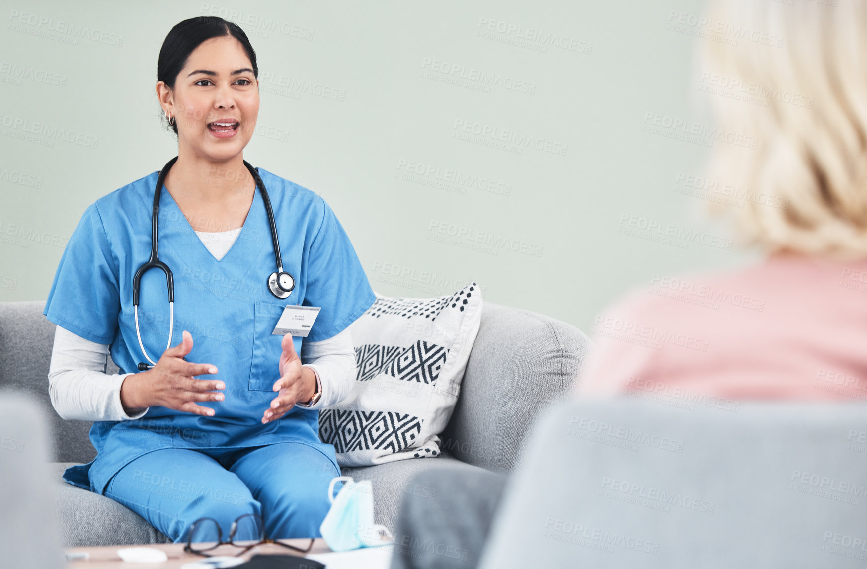 Buy stock photo Shot of a female nurse talking to a patient
