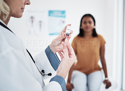 Buy stock photo Shot of a doctor giving a patient an injection at a clinic