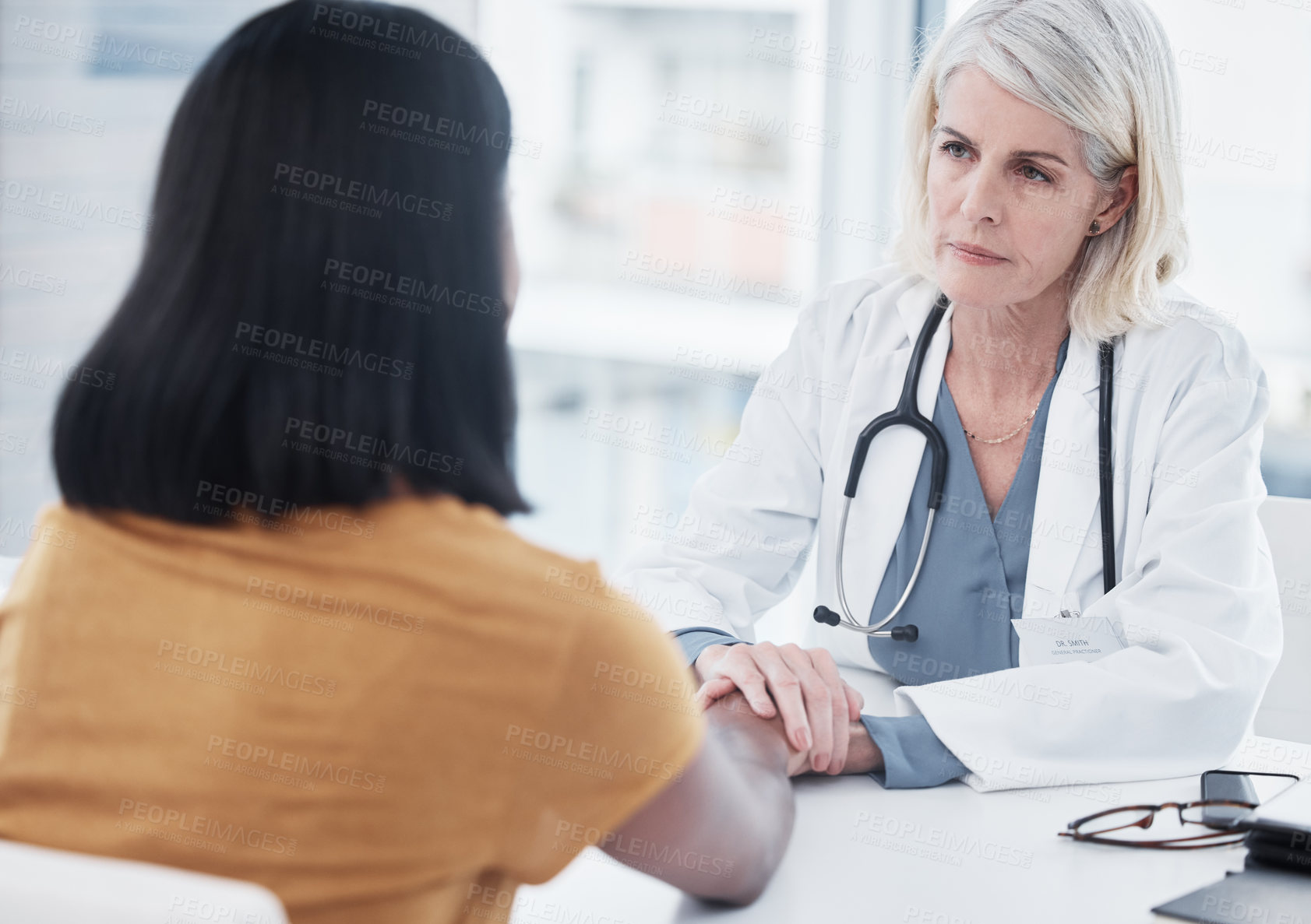 Buy stock photo Empathy, compassion and holding hands of doctor and patient for medical, trust and advice. Medicine, healthcare and help with women in hospital consulting room for depression, support and hope