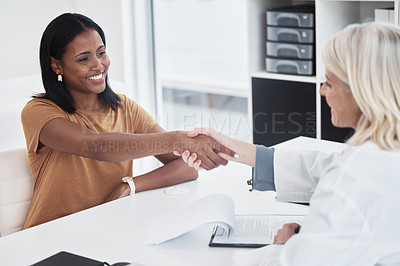 Buy stock photo Shot of a doctor shaking hands with a patient