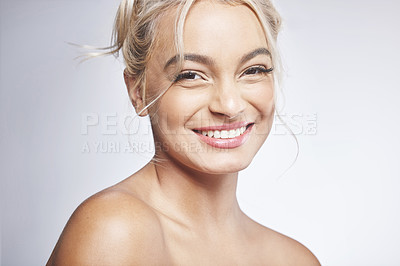 Buy stock photo Shot of an attractive young woman standing alone and posing against a grey background in the studio