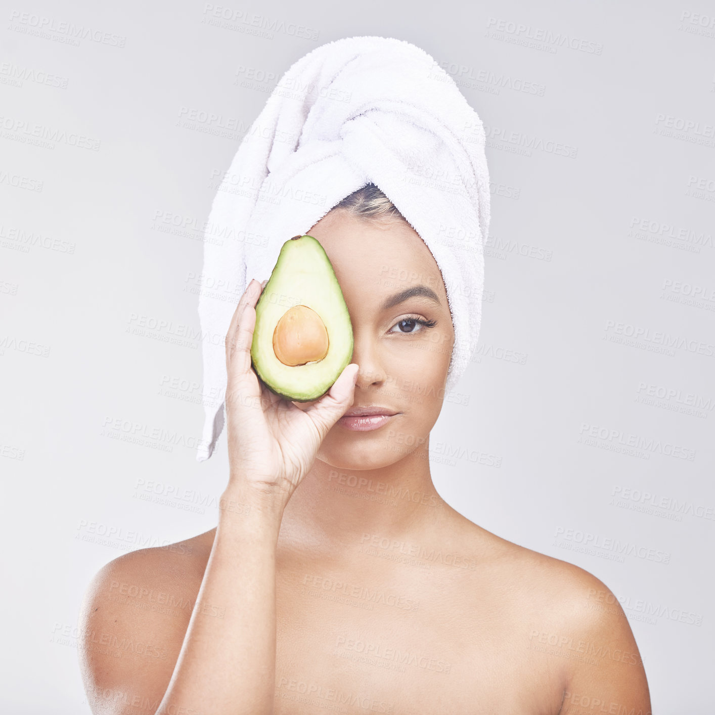 Buy stock photo Woman, portrait and skincare with avocado for natural beauty on a gray studio background. Face of female person or model with treatment, organic product or vegetable for anti aging or healthy skin