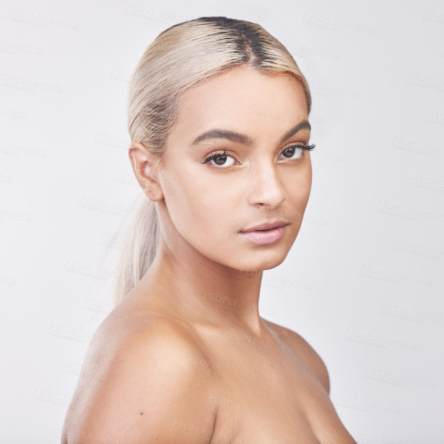 Buy stock photo Studio portrait of a beautiful young woman posing against a grey background