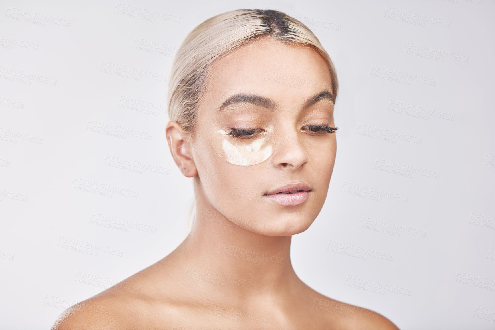 Buy stock photo Eye pad, collagen and woman in studio with skincare, natural and beauty facial treatment. Cosmetic, health and female person with gel dermatology product for face routine isolated by gray background.