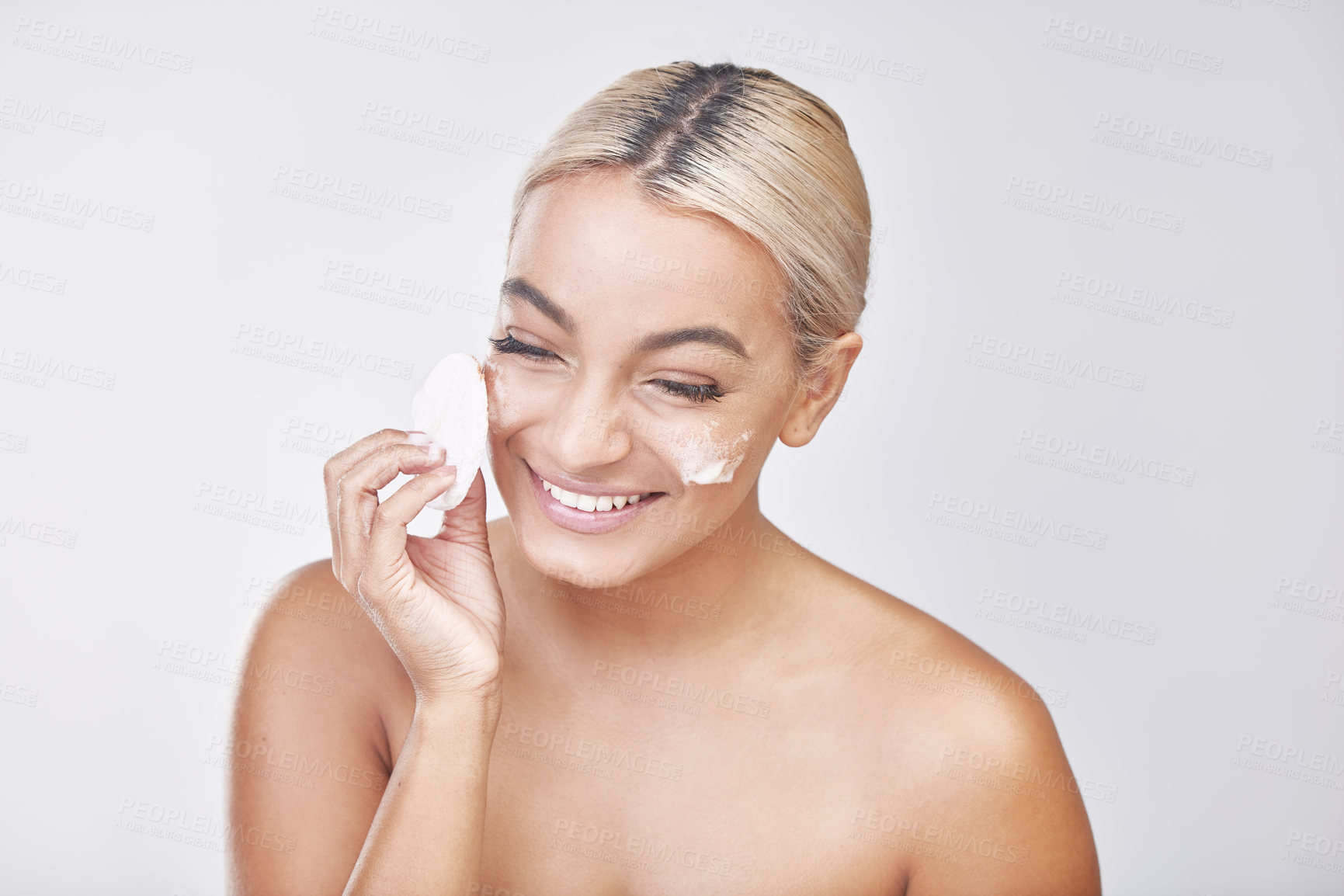 Buy stock photo Woman, happy and foam with cotton pad for skincare, dermatology and wellness in studio. Girl, smile and cosmetic  cream for beauty, cleaning and toner with facial glow on white background in France
