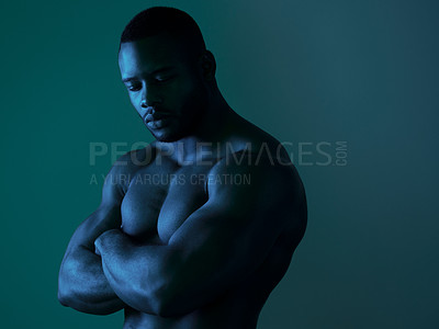 Buy stock photo Shot of a handsome young man posing topless in studio