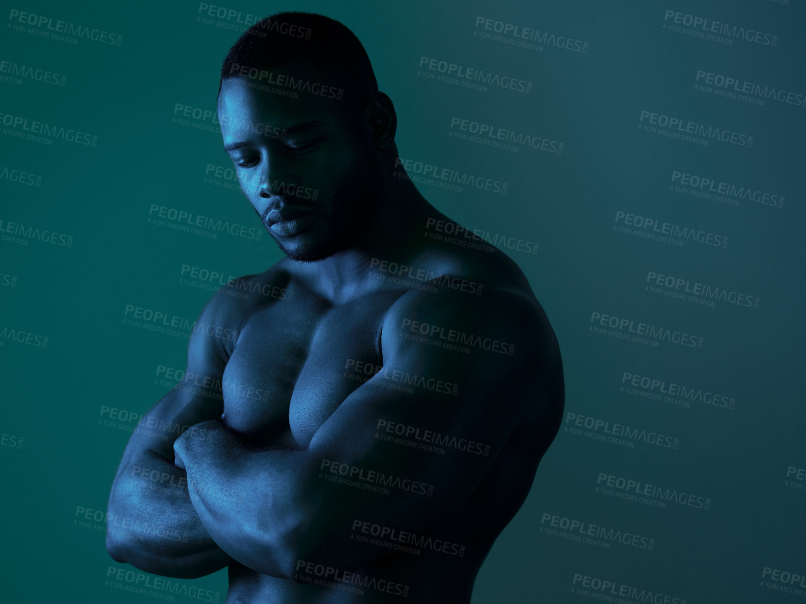 Buy stock photo Shot of a handsome young man posing topless in studio