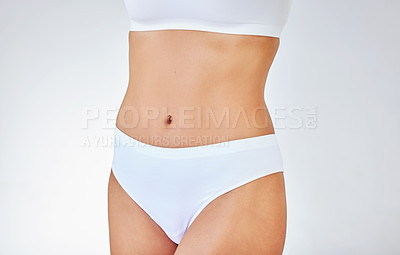 Buy stock photo Shot of a woman posing in her underwear against a studio background
