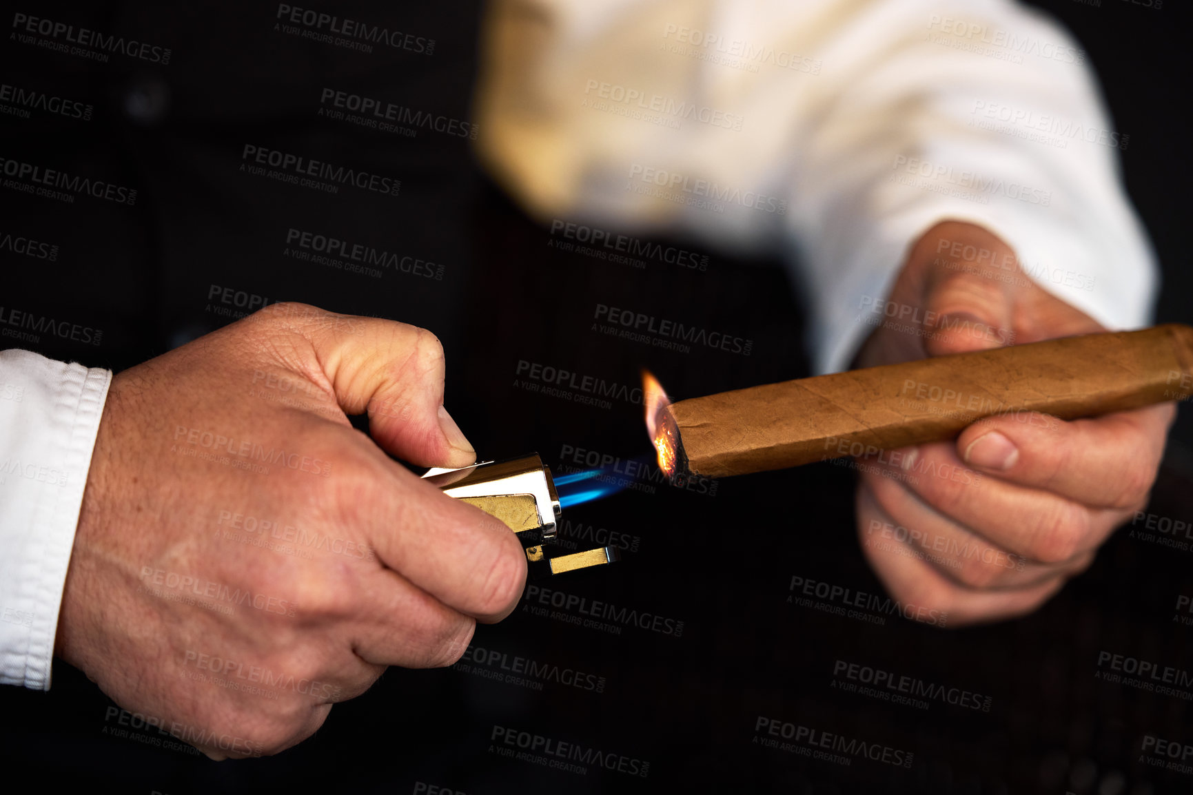 Buy stock photo Cigar, lighter and flame with hands holding luxury smoking product with blue light and tobacco. Cigarette, male person smoker and hand with fire, danger and rolled Cuban cigars during blackout