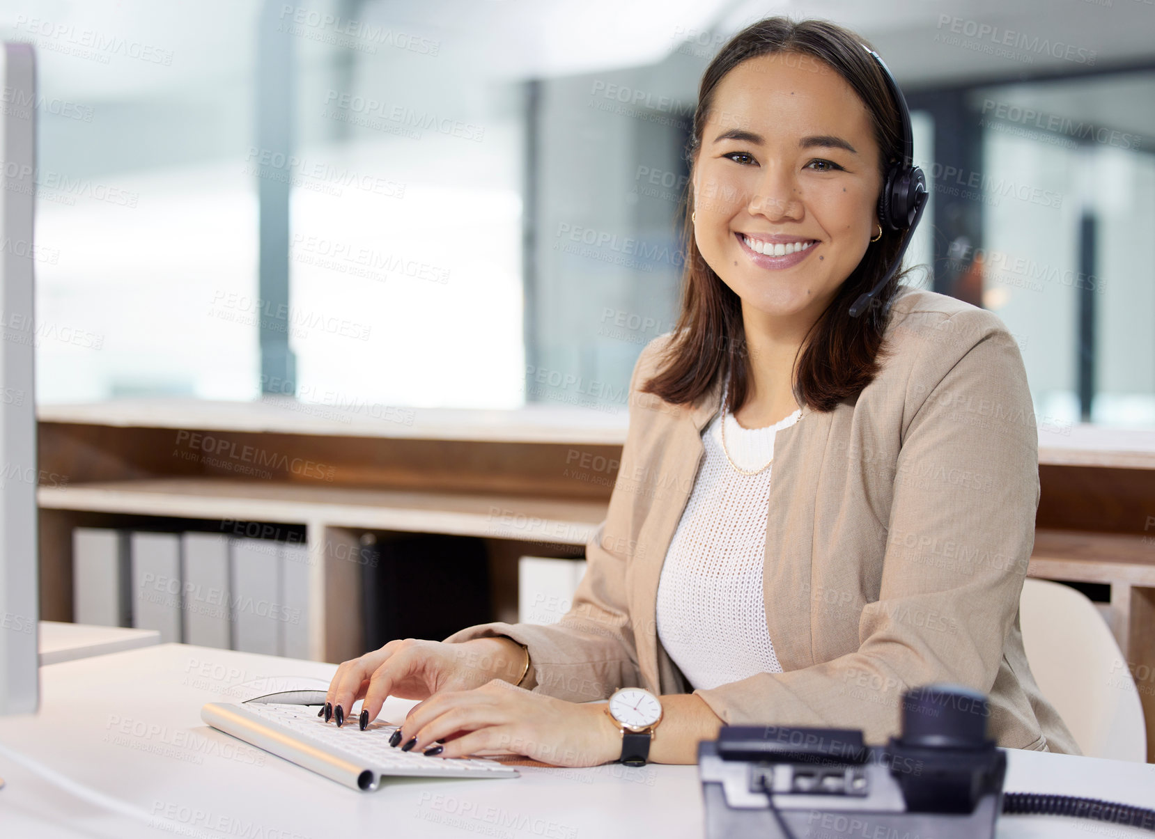 Buy stock photo Portrait of a young woman using a headset and computer in a modern office