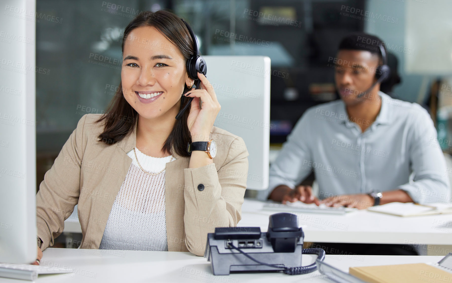 Buy stock photo Shot of a young woman using a headset and computer in a modern office