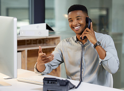 Buy stock photo Phone call, telephone and businessman talking in the office while working on a computer. Technology, happy and professional male employee in a conversation or discussion on landline in the workplace.