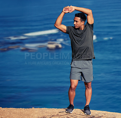 Buy stock photo Exercise, arms and man stretching by ocean before workout or morning training routine for race or wellness. Person, thinking and outdoor with fitness for warm up for marathon, cardio and health.