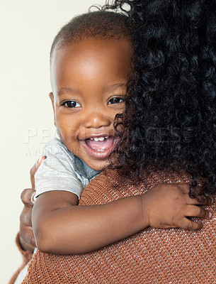 Buy stock photo Shot of an unrecognizable mother holding her adorable son at home during the day