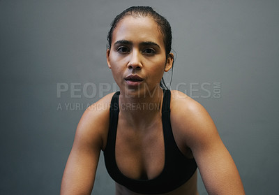 Buy stock photo Shot of an athletic woman sitting against a grey background