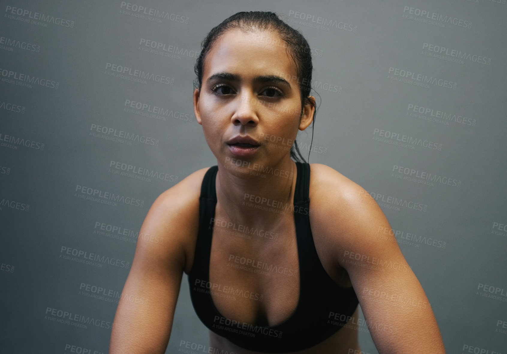 Buy stock photo Shot of an athletic woman sitting against a grey background