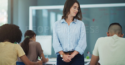 Buy stock photo Shot of an attractive professor watching her students complete their exams at university