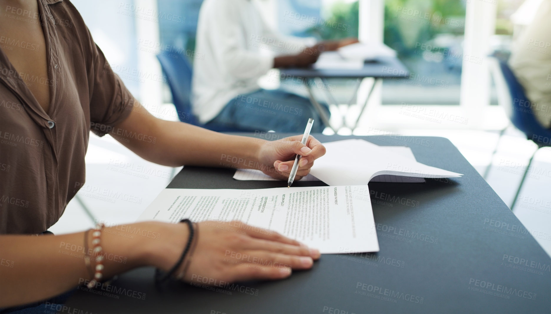 Buy stock photo Closeup shot of an unrecognizable woman completing her exam in a classroom at university