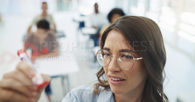Buy stock photo Woman, teacher and writing with students in classroom for lesson, learning or education at university. Face of female person or professor taking notes on board with academic group for presentation