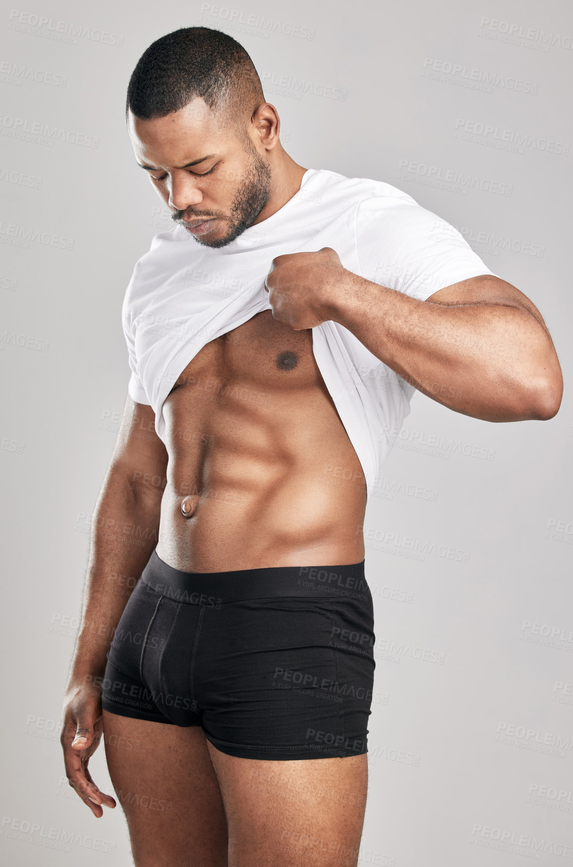 Buy stock photo Abs, African man and strong in studio with confidence, pride and fitness in underwear on backdrop. Male athlete, workout and body on grey background with stomach or torso for health or strength