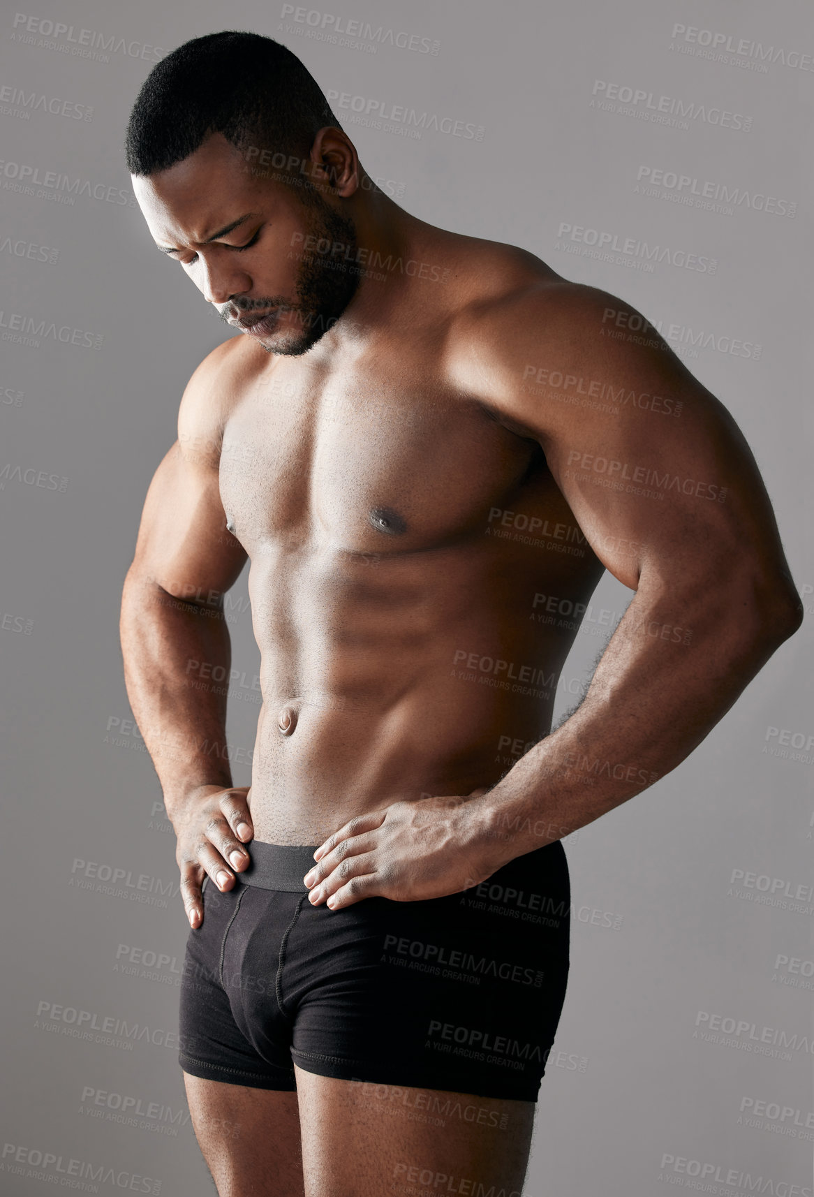 Buy stock photo Abdomen, muscle and black man in studio in underwear for fitness, exercise and body health. Confidence, shirtless or strong bodybuilder workout for energy, sport or power isolated on grey background