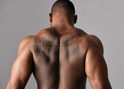 Buy stock photo Studio shot of a unrecognizable male flexing his back muscles against a grey background