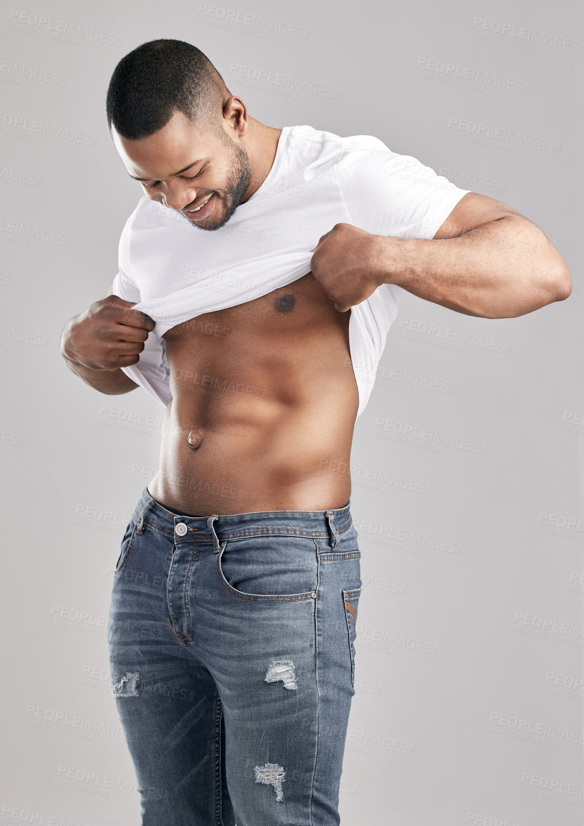 Buy stock photo Fitness, stomach and muscle with African man on studio backdrop for strength, body and health. Sports, wellness and abs with bodybuilder, tshirt and self care with male person on grey background 