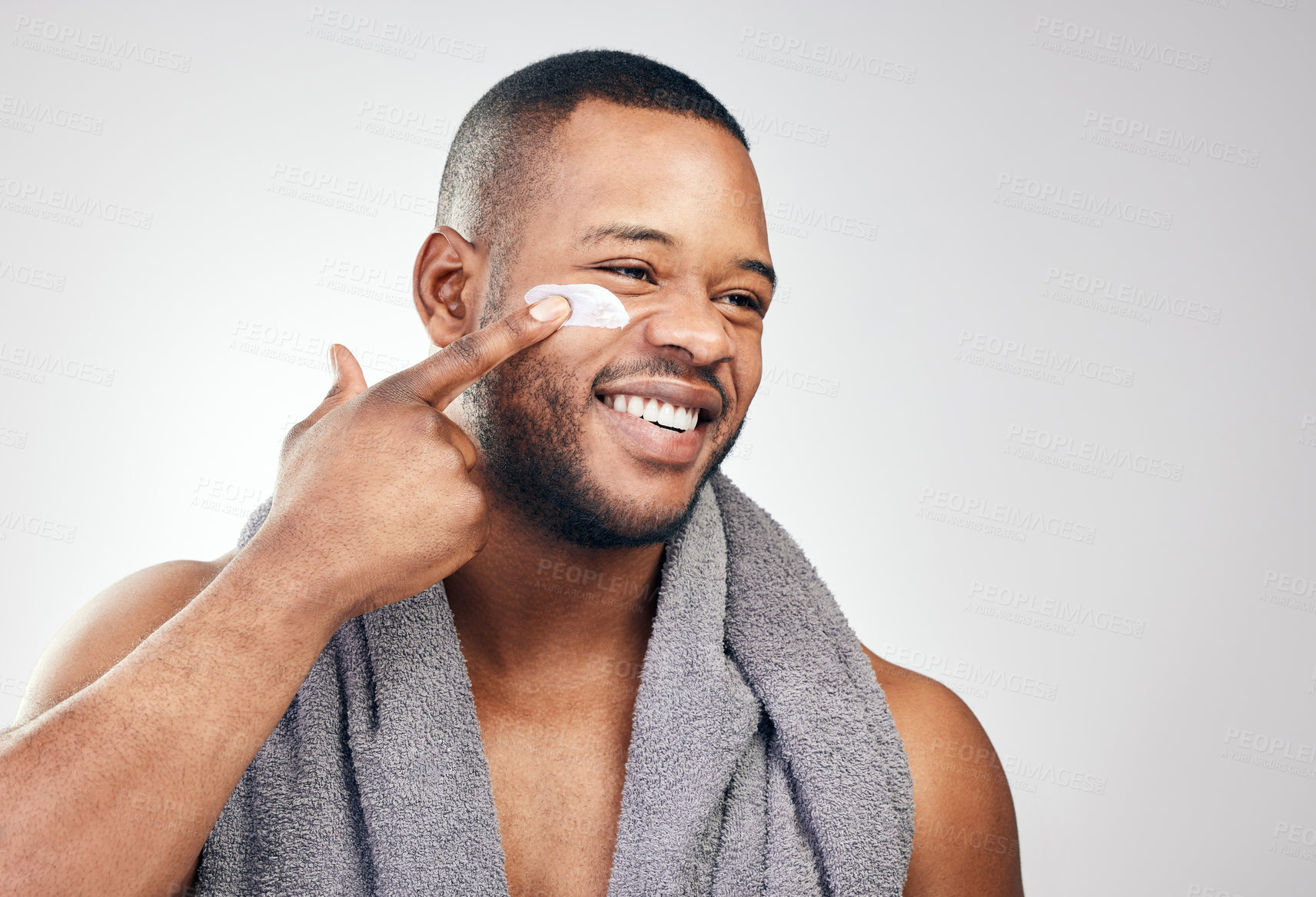 Buy stock photo Black man, face cream and smile in studio for beauty with application, cosmetics and pride by mockup. Male model, hand and skincare treatment with lotion, moisturizer and results by white background