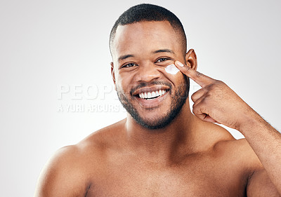 Buy stock photo Black man, face cream and portrait in studio for beauty with application, cosmetics and pride by mockup. Male model, hand or skincare treatment with lotion, moisturizer or results by white background