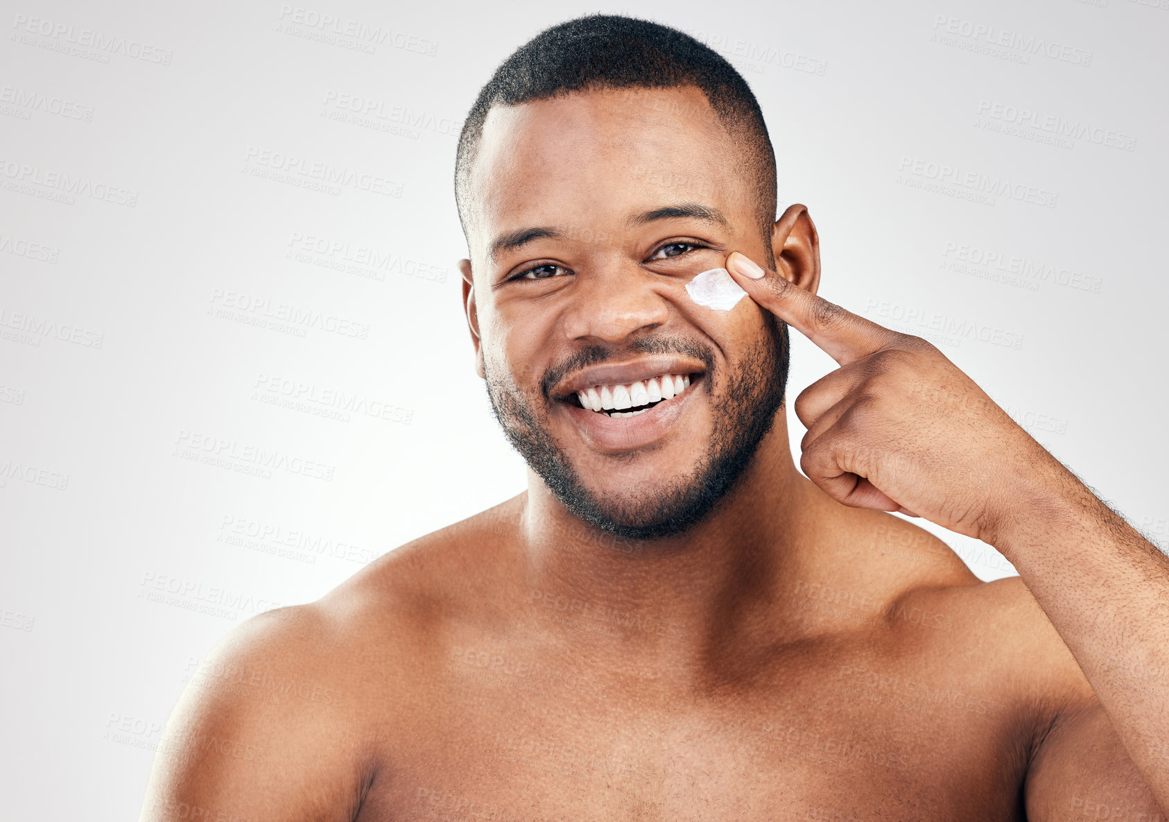 Buy stock photo Black man, face cream and portrait in studio for beauty with application, cosmetics and pride by mockup. Male model, hand or skincare treatment with lotion, moisturizer or results by white background