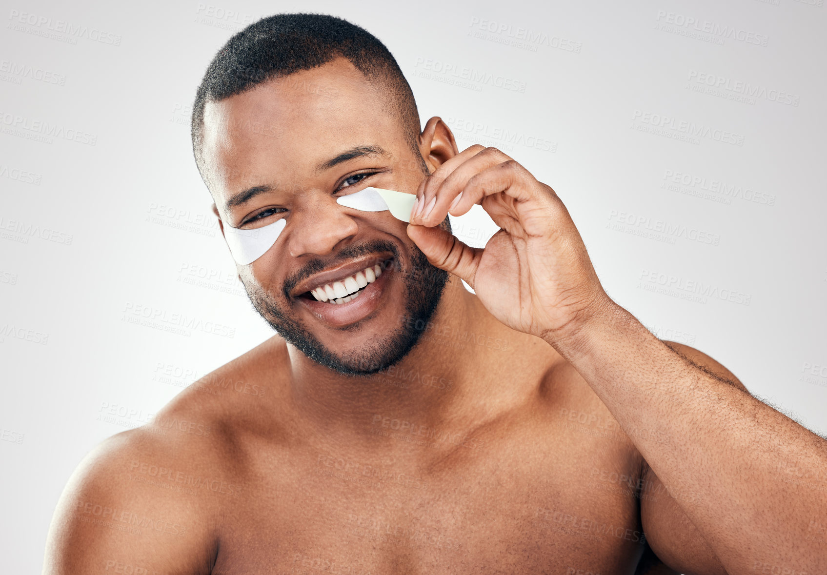 Buy stock photo Studio portrait of a handsome young man wearing under-eye patches against a white background