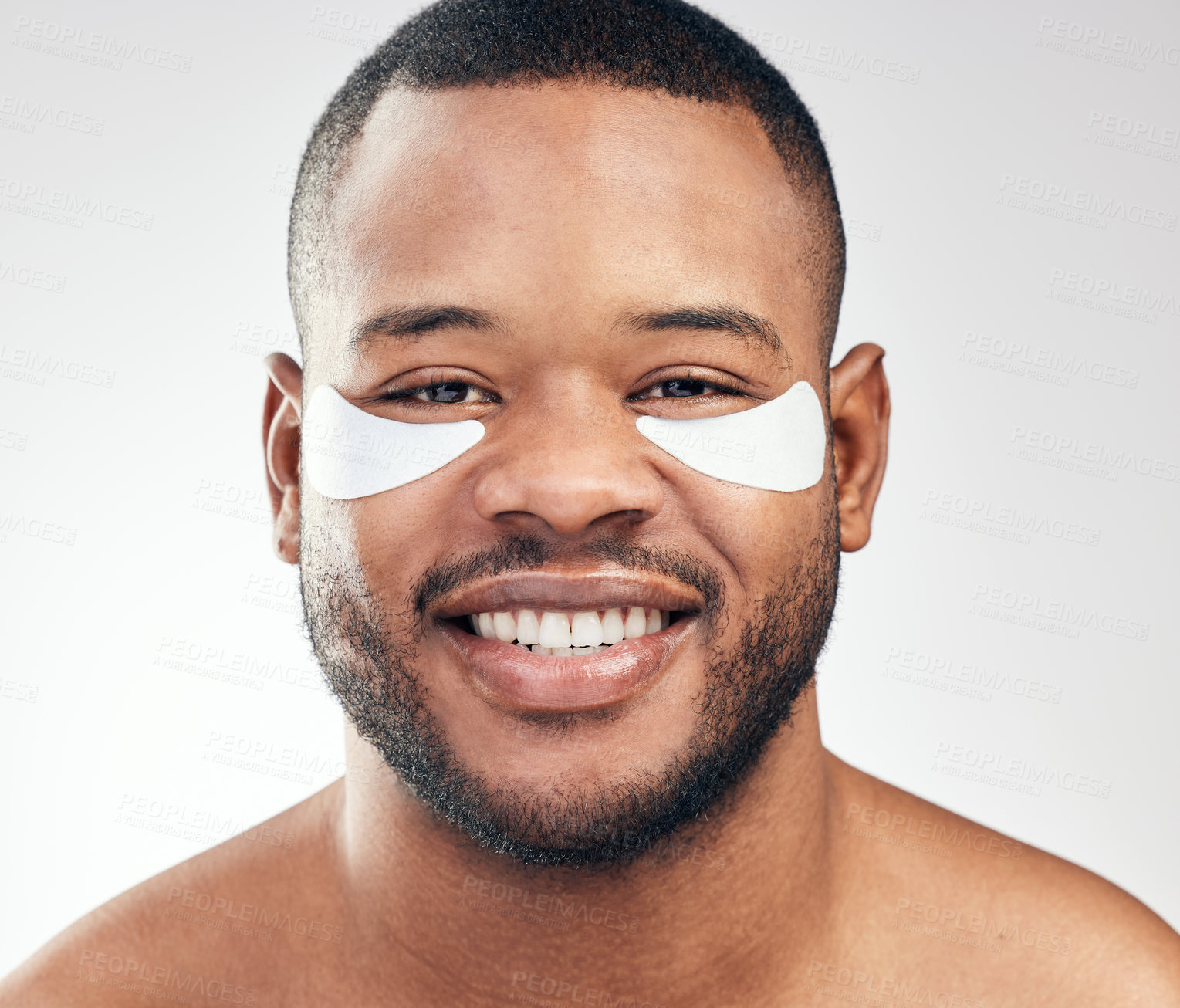 Buy stock photo Studio portrait of a handsome young man wearing under-eye patches against a white background