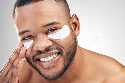 Buy stock photo Studio portrait of a handsome young man wearing under-eye patches against a white background