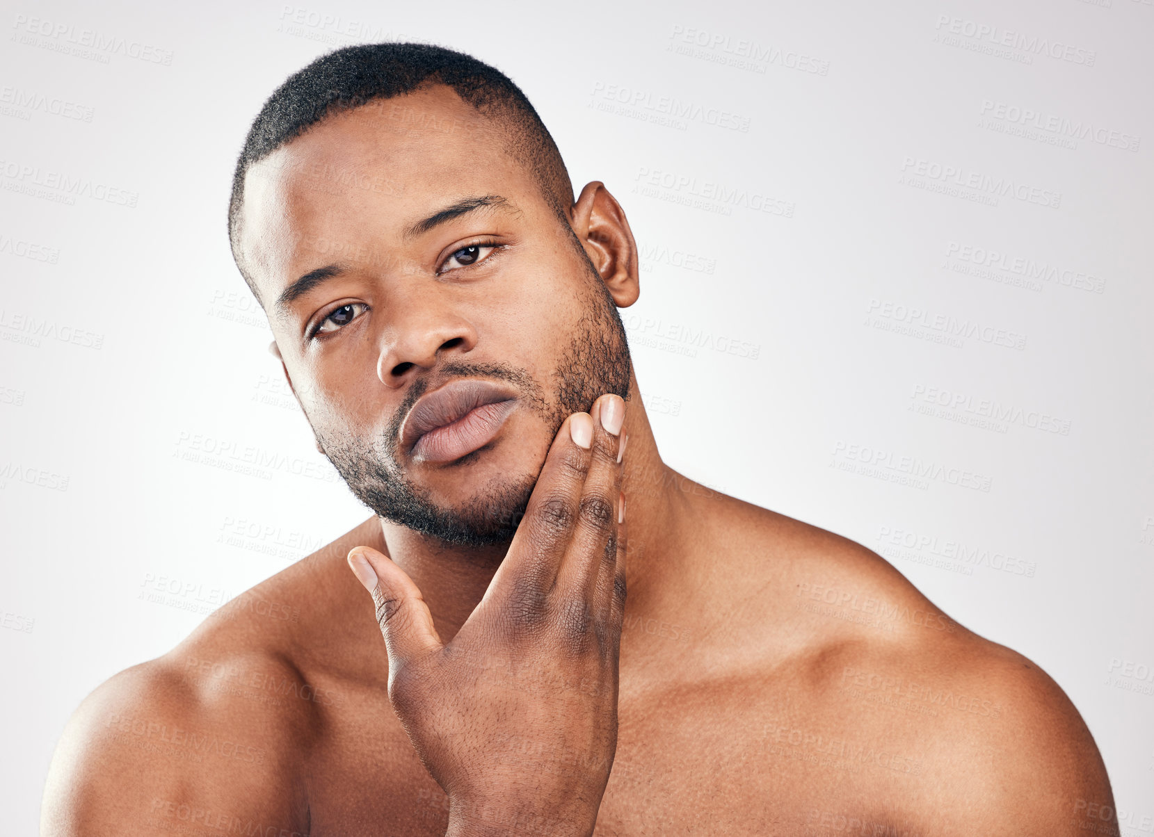 Buy stock photo Studio portrait of a handsome young man posing against a white background