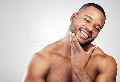 Buy stock photo Studio portrait of a handsome young man posing against a white background