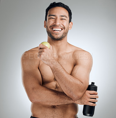 Buy stock photo Water bottle, apple and portrait of man in studio with fitness, exercise and healthy diet for nutrition. Smile, workout and shirtless athlete with h2o drink and fruit for hydration by gray background