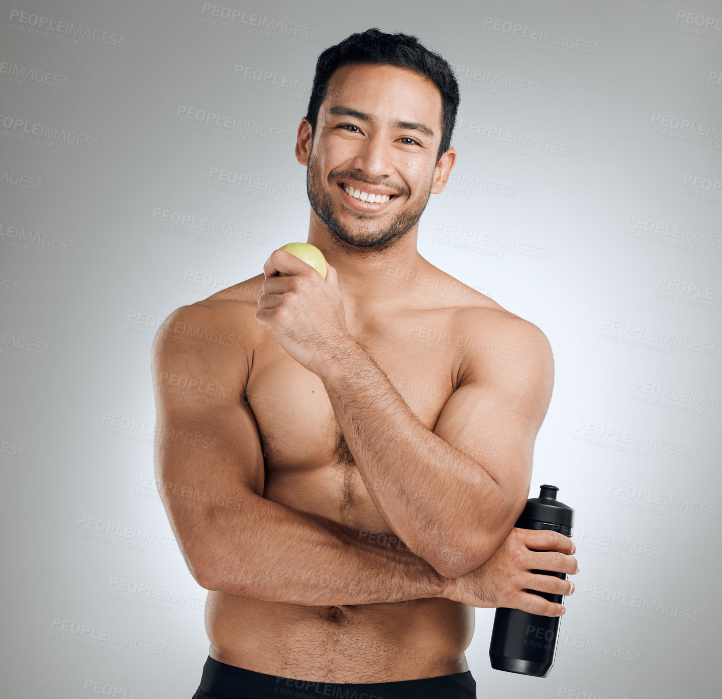 Buy stock photo Water, smile and portrait of man with apple in studio for fitness, exercise and healthy diet. Nutrition, workout and shirtless athlete with h2o drink and fruit for hydration by gray background.