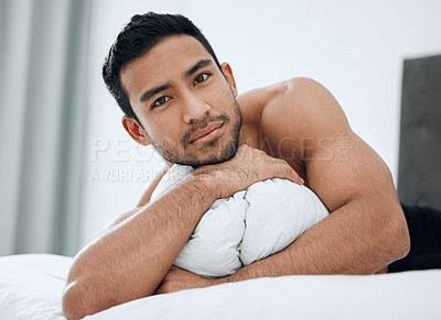 Buy stock photo Shot of a handsome young man lying on his bed