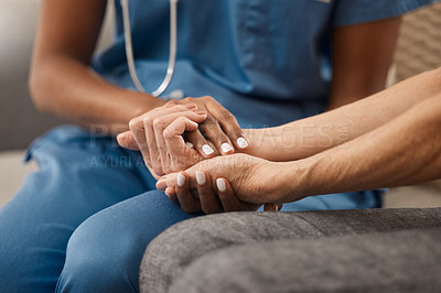 Buy stock photo Shot of a doctor holding hands with her patient during a consultation at home