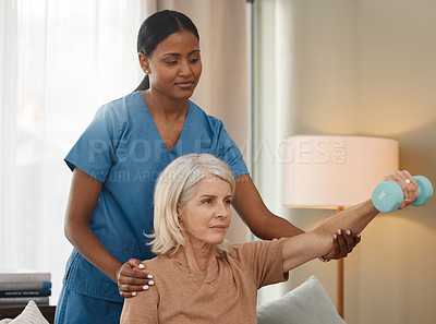 Buy stock photo Shot of a senior woman using dumbbells during an exam with her doctor at home