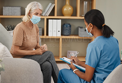 Buy stock photo Shot of a doctor having a consultation with a senior woman at home