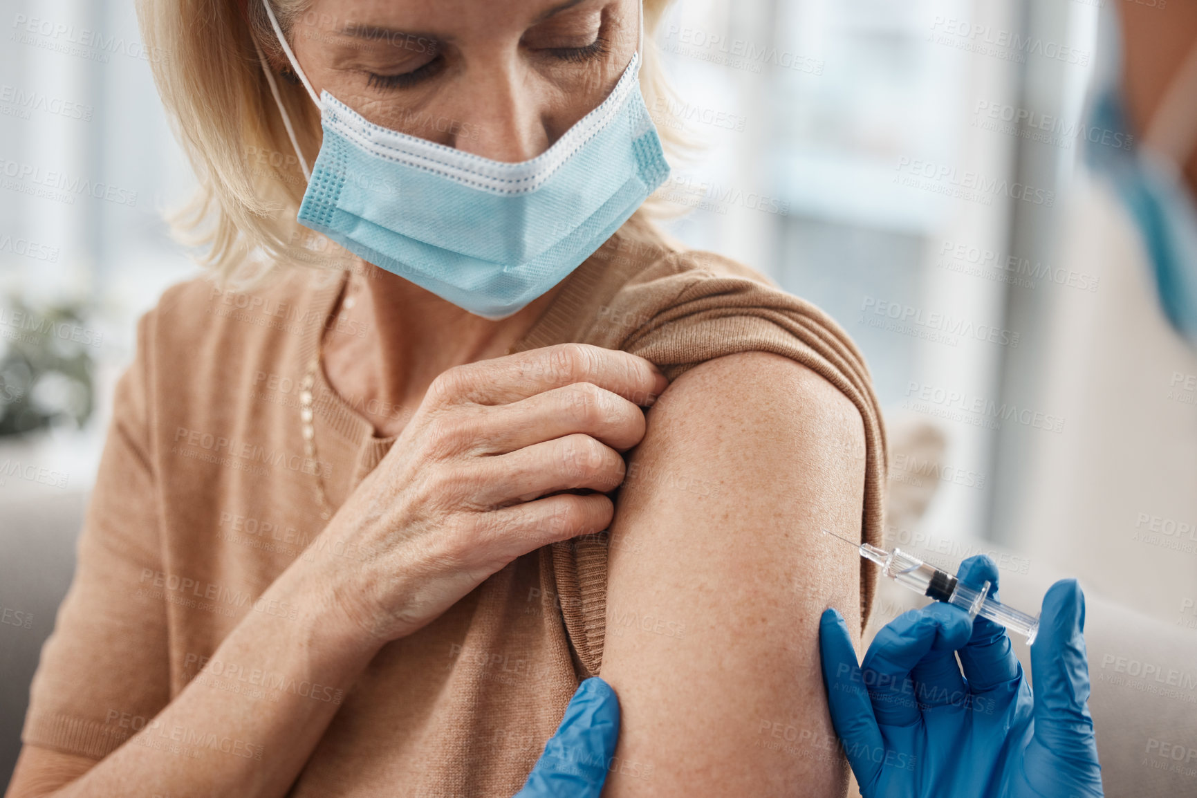 Buy stock photo Vaccine, doctor and senior woman on sofa for needle at medical consultation by nursing home. Syringe, checkup and hands of healthcare worker with elderly female patient for injection at house.