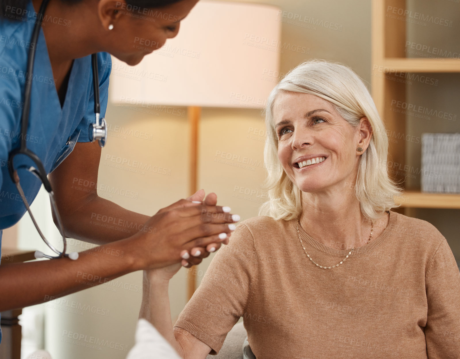 Buy stock photo Assisted living, healthcare or support with old woman and nurse on sofa in retirement home together. Conversation, happy and holding hands with senior patient talking to medicine professional